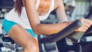 Lululemon military discount 2026 - woman in workout gear on an indoor cycling bike
