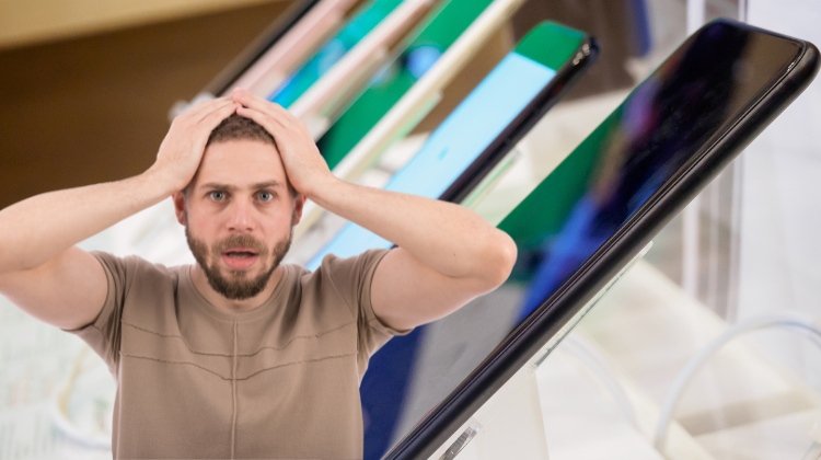 disappointed man with phones in background