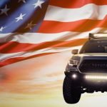 Toyota tacoma with American flag in background