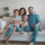 family sitting on couch in living room