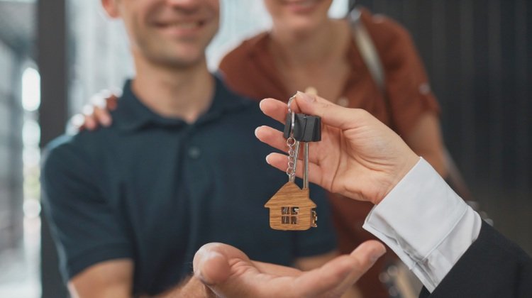 couple getting their house key from realtor
