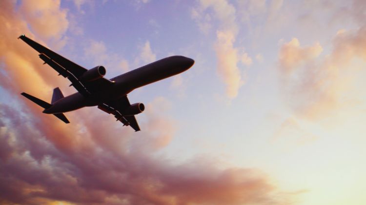 Commercial jet flying during sunset