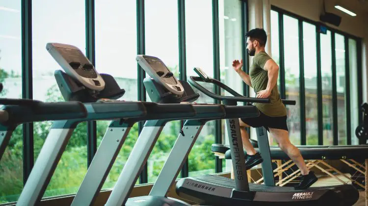 man running on treadmill in gym