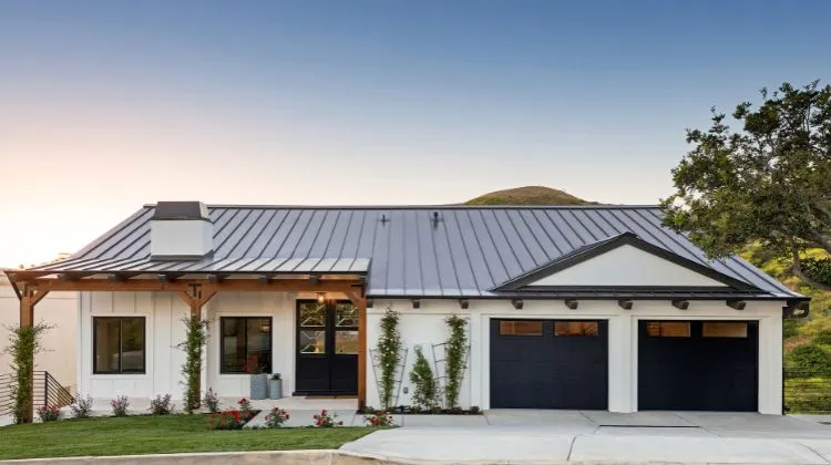 home with black accents around windows, doors, and garage