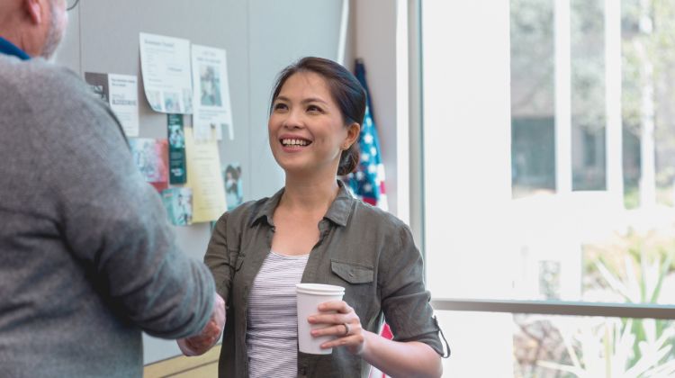 woman shaking hands with man