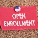 Note on cork board that says Open Enrollment