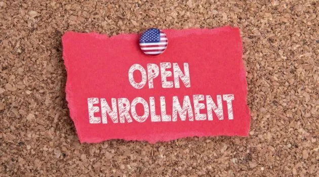 Note on cork board that says Open Enrollment