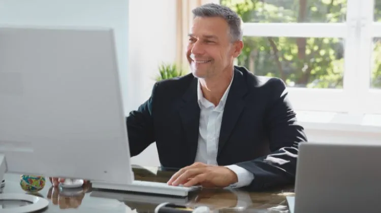 man sitting at computer