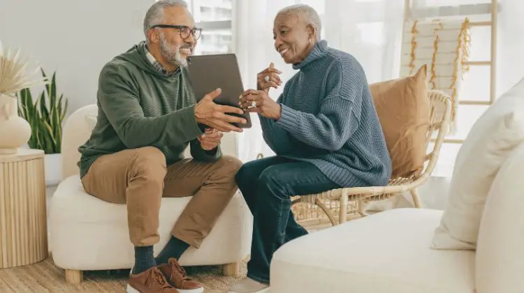 couple reviewing income on a tablet