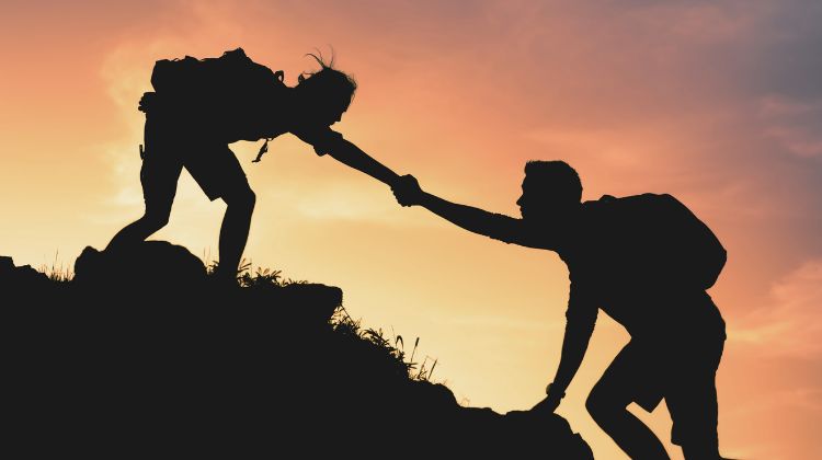 hikers lending a hand to each other 