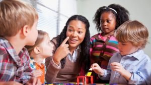 Teacher with young children in a classroom