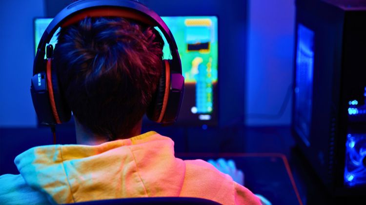 male playing video games with headset on