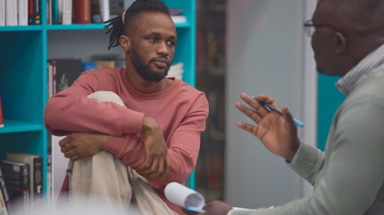 man speaking with mental health professional