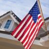 American flag in front of home with blue sky