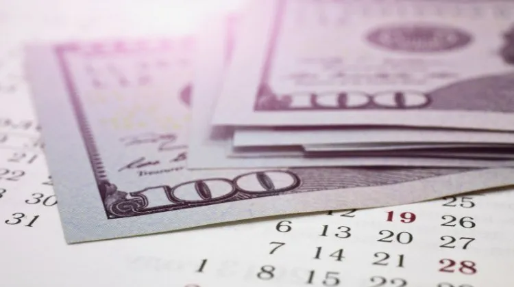 money on top of a desk calendar