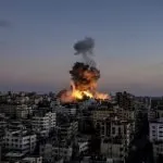 A large fire is burning in a city
