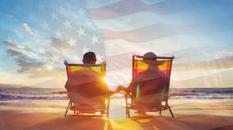 couple sitting on a beach with a transparent American flag over the image