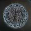 silver round coin on black textile