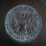 silver round coin on black textile