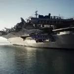 gray Navy aircraft carrier on body of water