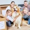 family sitting together on the floor with their dog during a new household move
