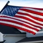 American flag in front of homes in a neighborhood