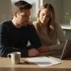 couple sitting at kitchen table using va loan funding fee calculator